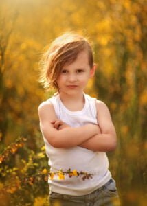 portrait of a boy in white t-shire surrounder yellow flowers, children family portrait photographer Nottingham, Derby, Eastwood,
