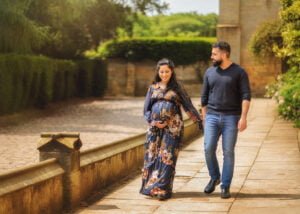 Outdoor maternity photography in Nottingham with floral dress and romantic couple walk