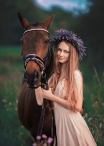 A woman with a floral crown shares a serene moment with a horse amidst the wildflowers of Nottingham.