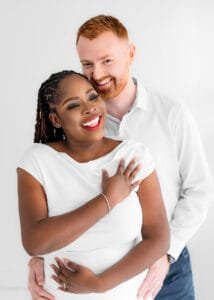 Romantic birthday photography of a couple in a cozy embrace, both dressed in white.