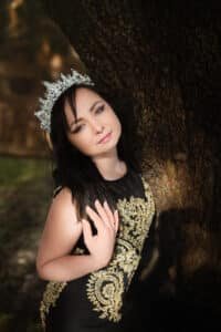 Empowered Birthday Celebration: Woman in Black Gown and Crown