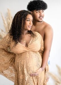 Expectant couple in a loving pose, captured by Nottingham's go-to family photographer in Eastwood.