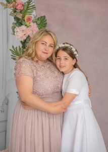 Mother hugging daughter during First Holy Communion Photography in Nottingham studio