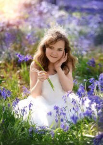 Smiling girl with tiara and flowers during First Holy Communion Photography in Nottingham