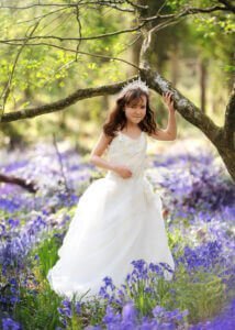 Girl in white dress during outdoor First Holy Communion Photography session in Nottingham woodland