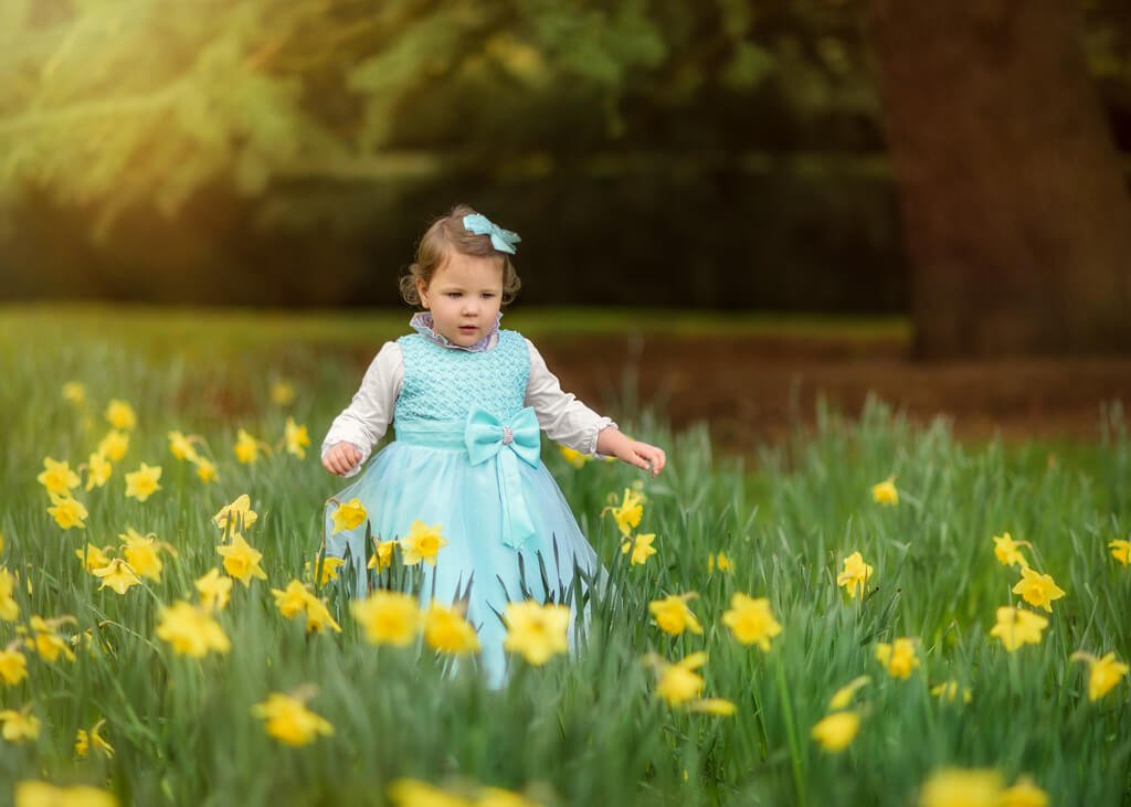 Nottingham Family Photography - Girl playing among blooming daffodils at Elvaston Castle during a spring family outdoor photoshoot