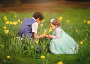Nottingham Family Photographer - Siblings having fun among blooming daffodils during a spring family outdoor photoshoot at Elvaston Castle.