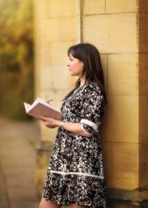 Nottingham Family Photographer - Portrait of a mum holding her diary in a black and white dress next to Elvaston Castle during a family outdoor photoshoot in spring.