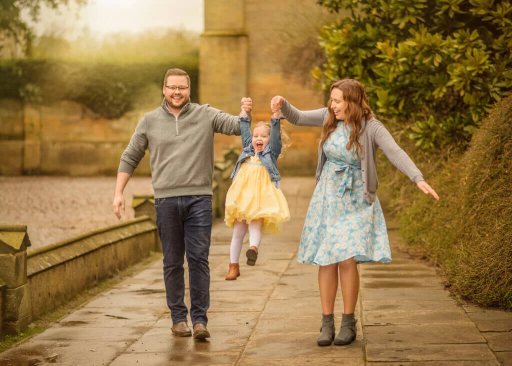 Happy family enjoying a joyful outdoor moment with the best Nottingham photographer during a family photoshoot