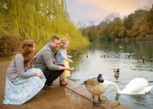 A joyful family gathers together outdoors for a memorable photoshoot, capturing their true essence and creating lasting memories.