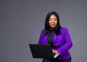 Businesswoman holding a laptop during a branding photoshoot in Nottingham Studio for a business coach's website.
