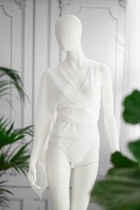 Soft white wrap bodysuit with draped sleeve for portrait photography