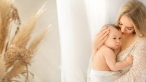 A serene moment of motherly love, as a Nottingham photographer captures a mother gently cradling her child, their bond timeless and pure.