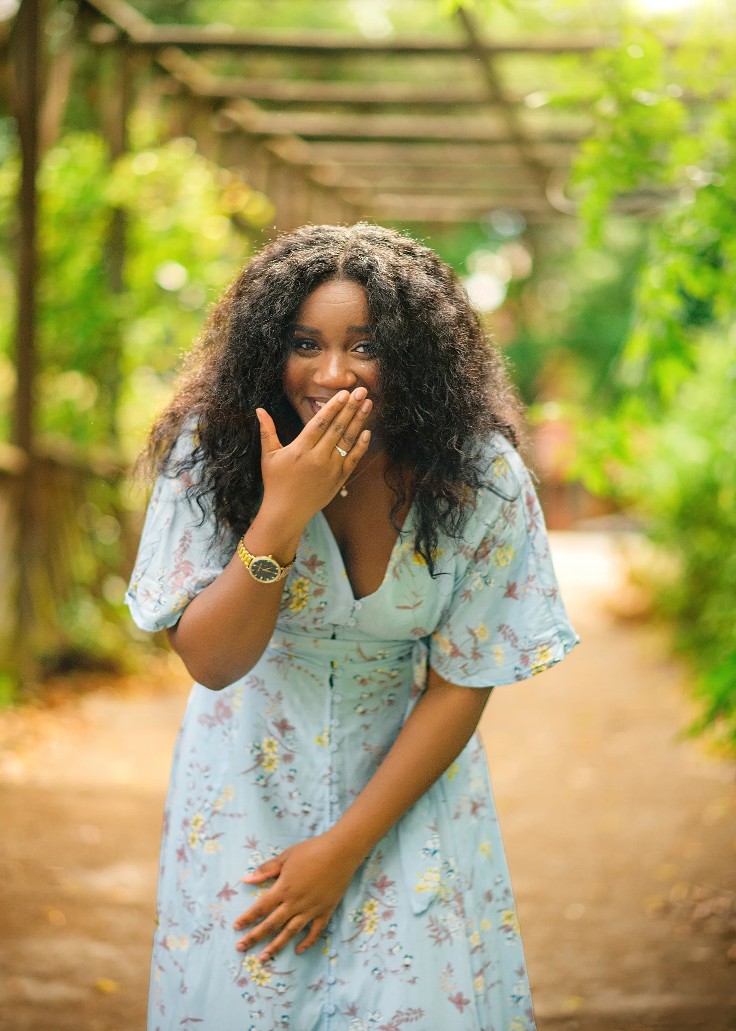 Overjoyed woman showing off her engagement ring, her surprise and delight captured in a natural Nottingham setting.