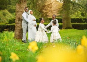 Outdoor maternity photoshoot in Nottingham with a family playing together in a spring garden