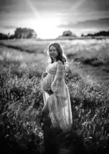 Expectant mother backlit by the sun in a dramatic black and white maternity photography session in Nottingham.