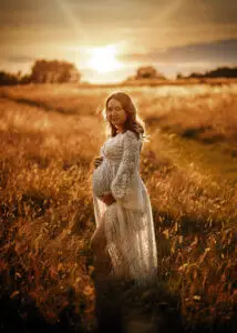 Pregnant woman glowing in the golden hour light during a maternity photo shoot in Nottingham.