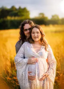 Loving couple during a maternity photoshoot with Nottingham’s sunset in the backdrop.