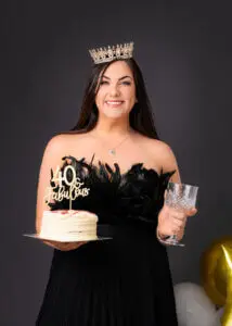 Woman with a '40 Fabulous' cake and crown during her 40th birthday photoshoot.