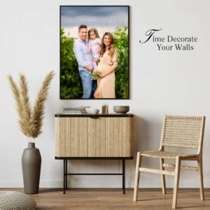 Family portrait of expecting parents and daughter displayed on a stylish wall during a maternity photo shoot in Nottingham