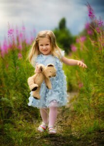 Little girl holding a teddy bear during a maternity photo session in Nottingham