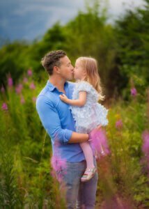 Father kissing his daughter during a maternity photo shoot in Nottingham