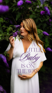 Expecting mother in a white dress standing among purple flowers with a baby announcement overlay
