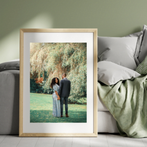 Framed outdoor couple photography portrait leaning against a couch, showing love in nature.