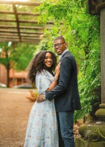 Couple embracing under a pergola during their outdoor couple photography session in Nottingham.