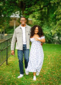 Couple walking arm in arm during their engagement photography session in Nottingham.