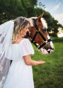 Bride-like woman with her horse during an equine photoshoot