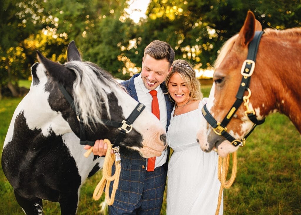 Couple embracing their horses during an equine photoshoot