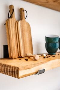 Close-up of wooden shelf with coffee beans and honey dipper, captured in high-quality product photography in Nottingham.