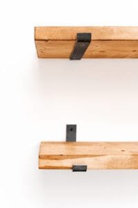 Close-up of rustic wooden shelf with metal bracket, captured in Nottingham product photography studio.