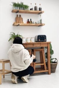 Professional photographer capturing styled wooden shelves in Nottingham product photography studio.