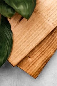 Close-up of rustic wood grain with green leaf, photographed for Nottingham product photography studio.