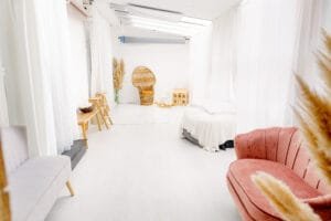 Bright and cozy Nottingham family photography studio with natural light, props, seating, and white curtains in Eastwood