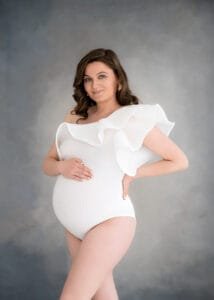Pregnant woman wearing one-shoulder bodysuit – maternity photoshoot in Nottingham