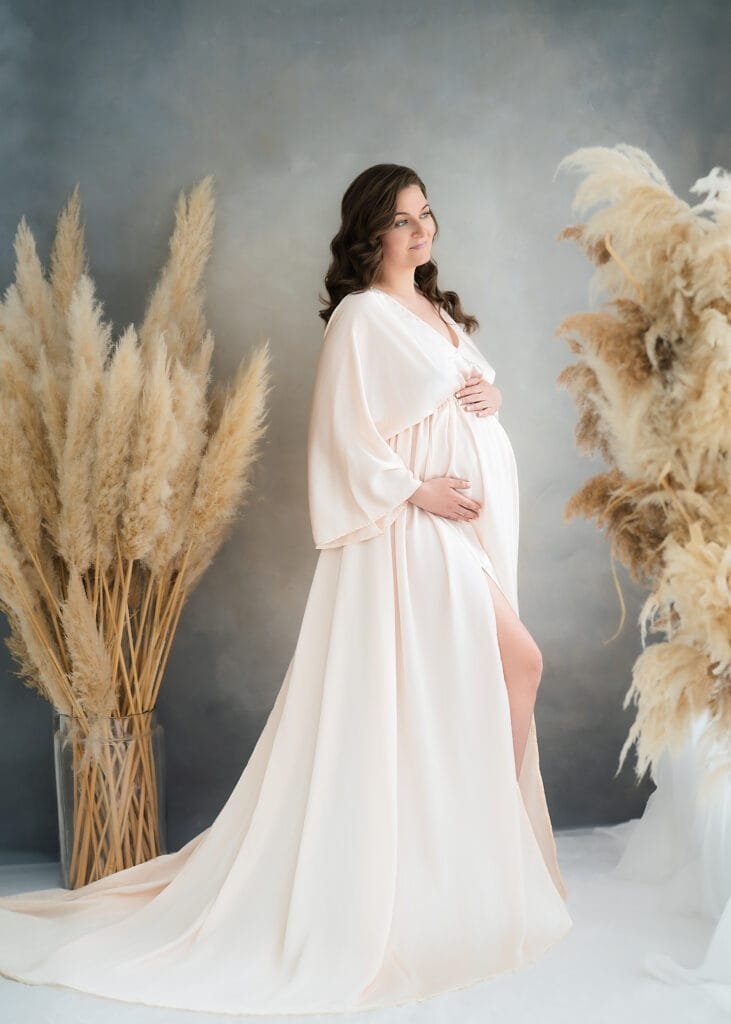 Maternity shoot in peach dress under blooming tree – Nottingham