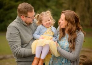 Happy family laughing together during an outdoor family photoshoot in Nottingham by Nottingham Family Photographer