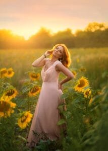 Woman portrait photoshoot in sunflower field at golden hour in Nottingham, elegant feminine outdoor photography with warm sunset light