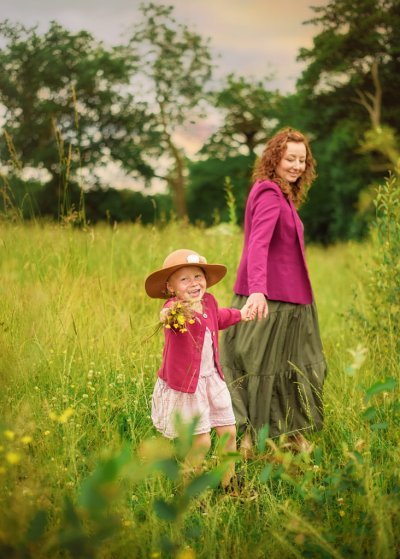 Mother and daughter walking hand-in-hand during an outdoor family photoshoot in Nottingham.